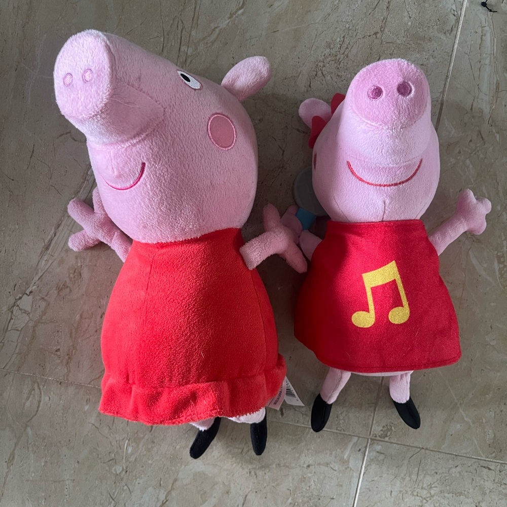 Two Peppa Pig stuffed animals. Makes noise.